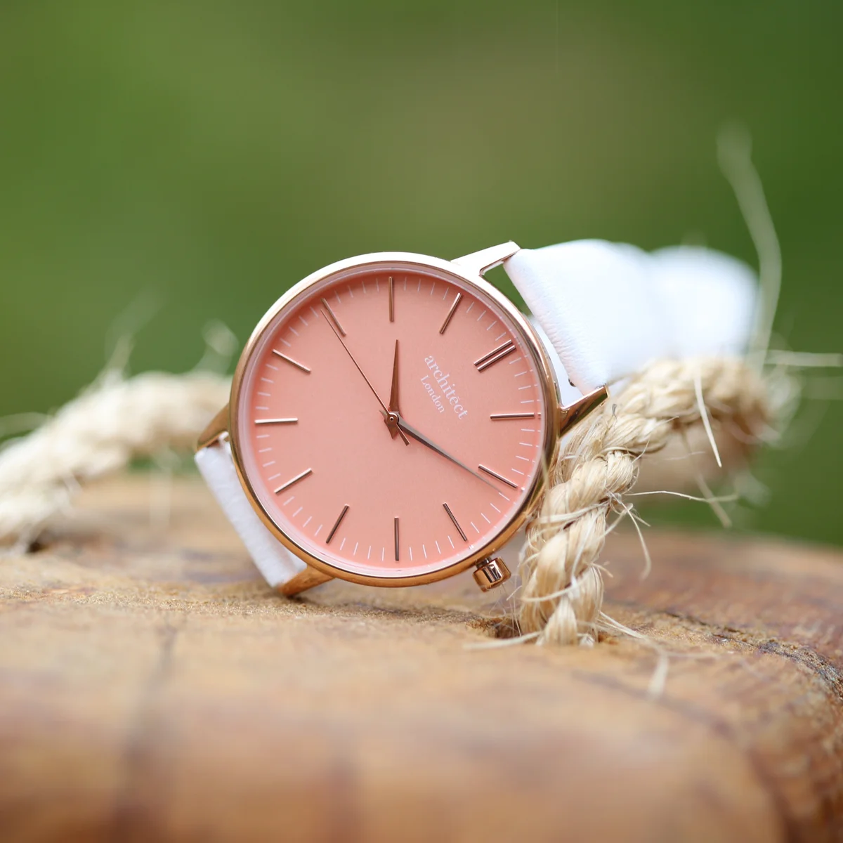 Ladies Architēct Coral quartz movement watch with apricot coral dial, white leather strap, and stainless steel case
