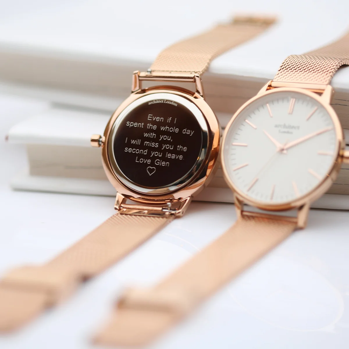 Personalised ladies watch with rose gold mesh strap, stainless steel case, and minimalist white dial on white background