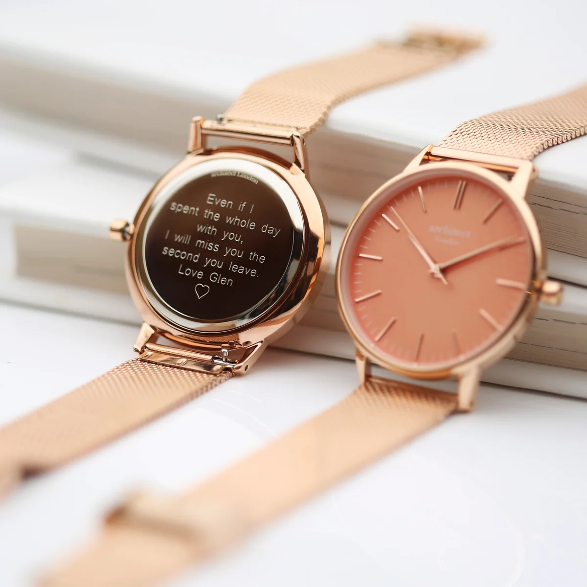 Ladies coral watch with apricot dial, rose gold mesh strap, and polished stainless steel case on white background
