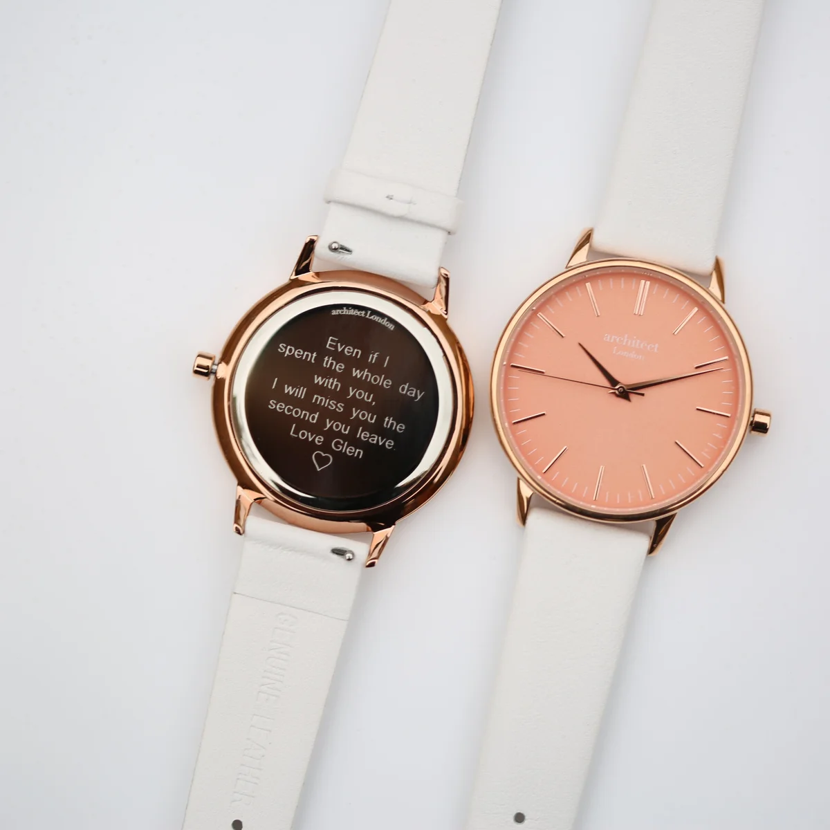 Ladies coral watch with modern font engraving, polished stainless steel case, and white leather strap watch on white background