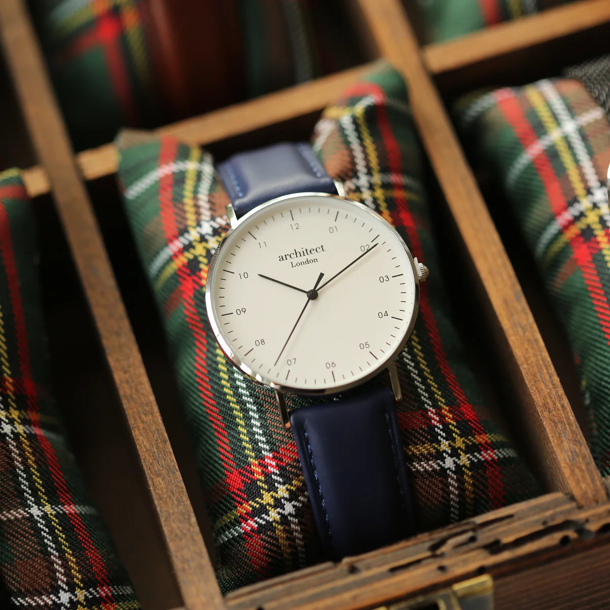 Personalised men's watch with minimalist gunmetal case, blue leather strap, and engraved back in handwriting style