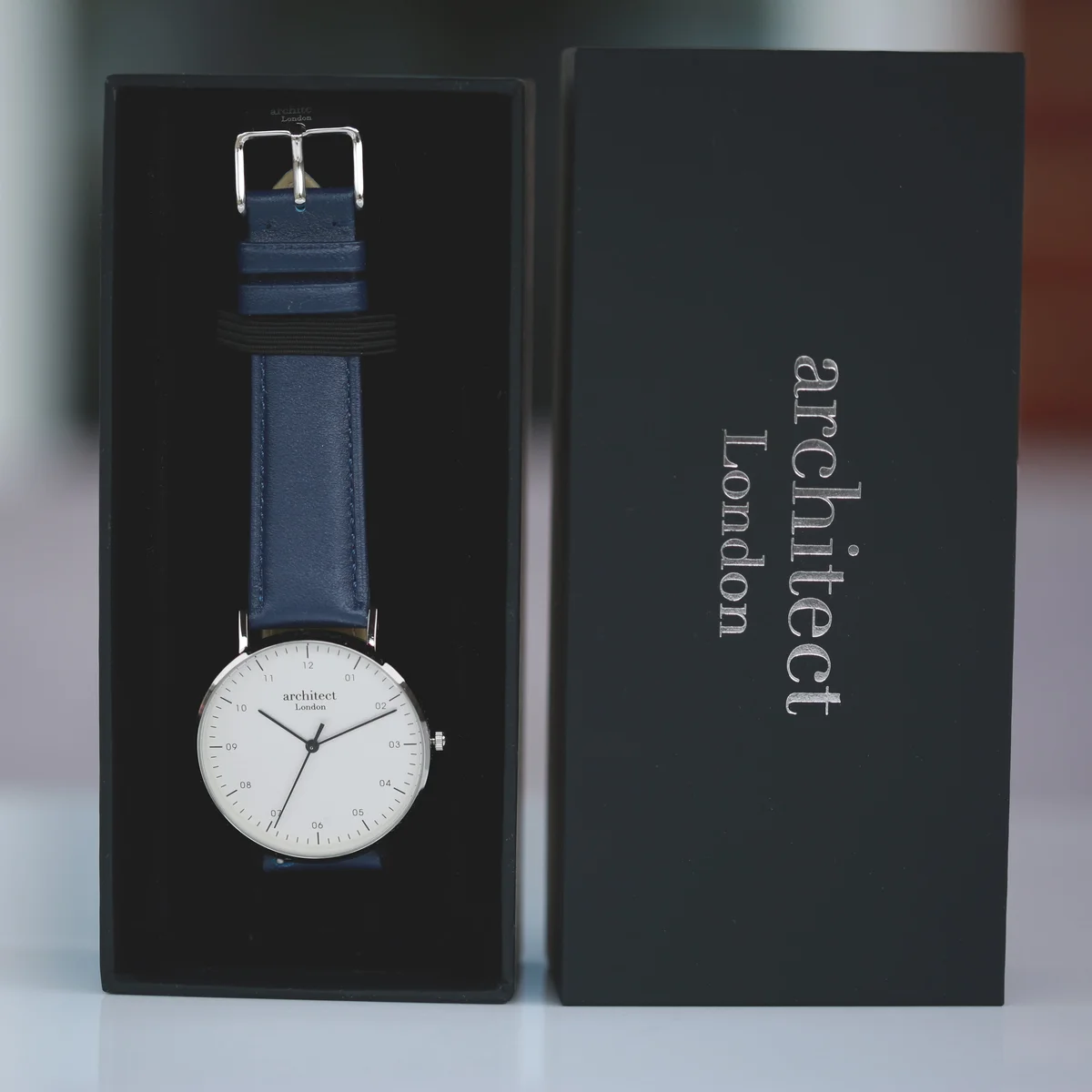 Engraved men's watch with sandblasted gunmetal case and Admiral blue genuine leather strap on white background