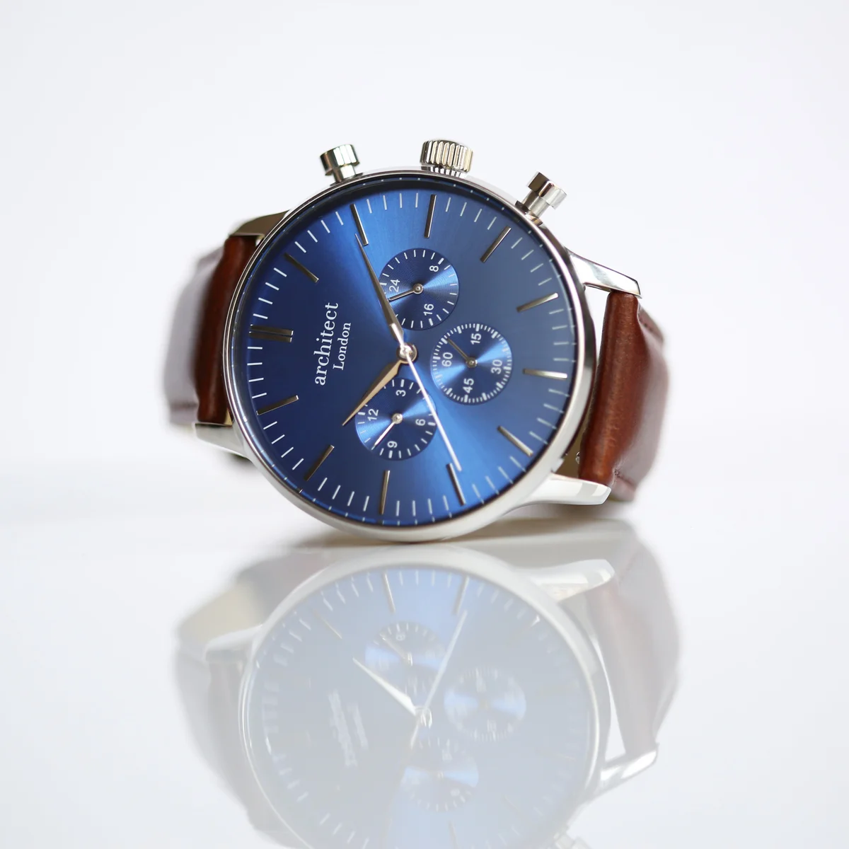 Men's leather strap watch with deep-space blue dial, three chronograph subdials, and walnut brown leather band