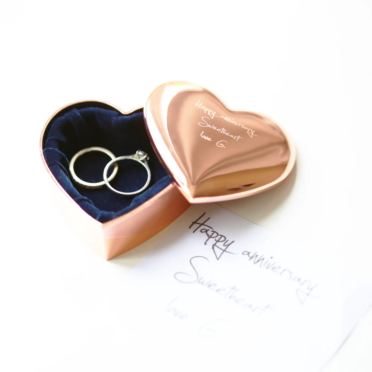 Highly polished rose gold keepsake box in heart shape engraved with personalised handwriting on the lid