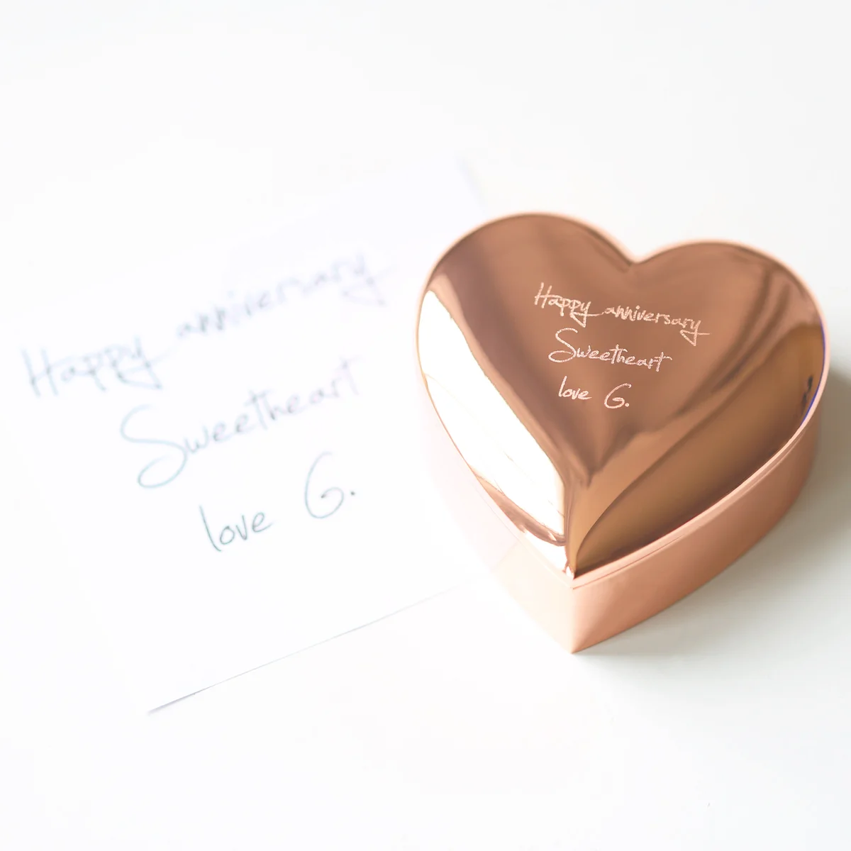 Rose gold heart shaped keepsake with polished finish and custom handwriting engraving on the lid, open showing interior space