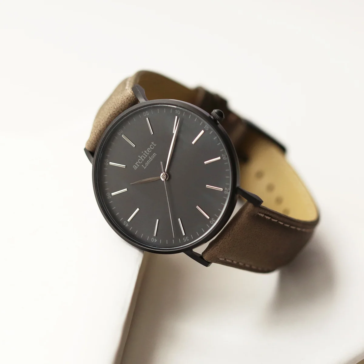 Men's minimalist watch with sandblasted gunmetal stainless steel case and urban grey genuine leather strap on white background
