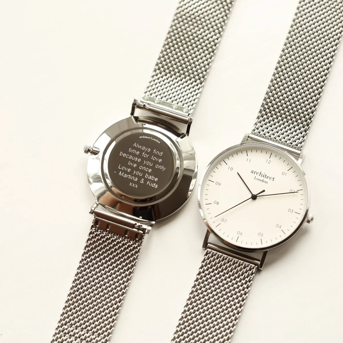 Engraved men's watch with silver mesh strap, stainless steel case, minimalist dial, and modern font engraving space on back