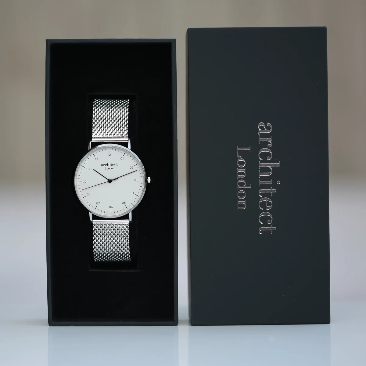 Men’s personalised quartz watch with silver mesh strap and modern font engraving on stainless steel case back