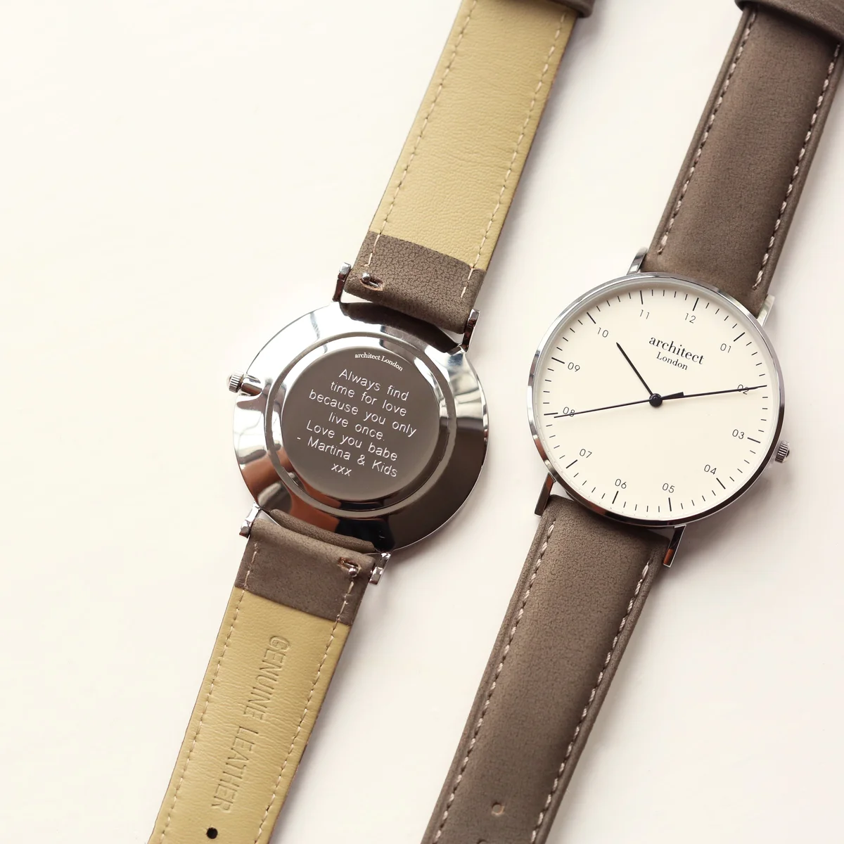 Men's minimalist watch with stainless steel case, modern font engraving, and urban grey genuine leather strap on white background