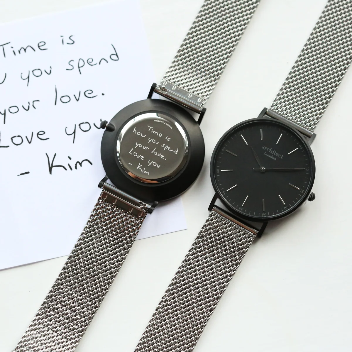 Personalised men's watch with minimalist silver mesh strap and stainless steel case, shown on white background