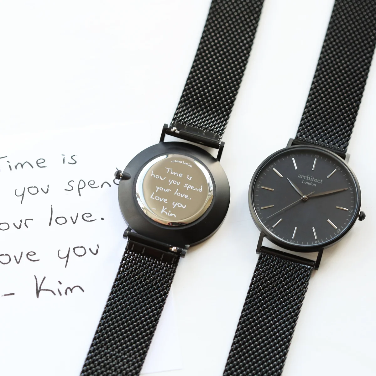 Personalised men's watch with pitch black mesh strap and brushed stainless steel case on white background