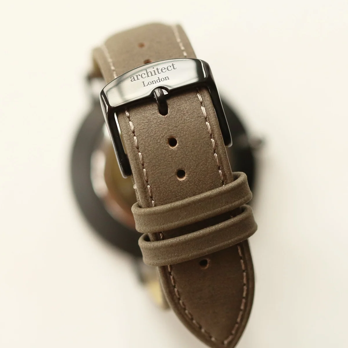 Men’s minimalist quartz movement watch with urban grey leather strap and brushed stainless steel case on white background