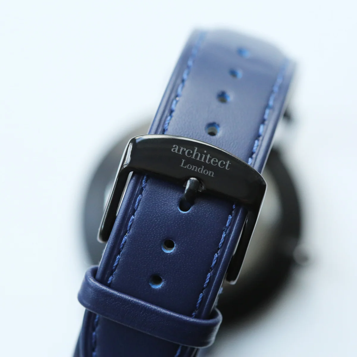 Minimalist men's quartz movement watch with admiral blue leather strap and stainless steel case on white background