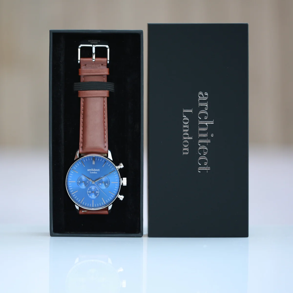 Men’s personalised watch with deep-space blue dial, walnut brown leather strap, and three chronograph subdials on wrist