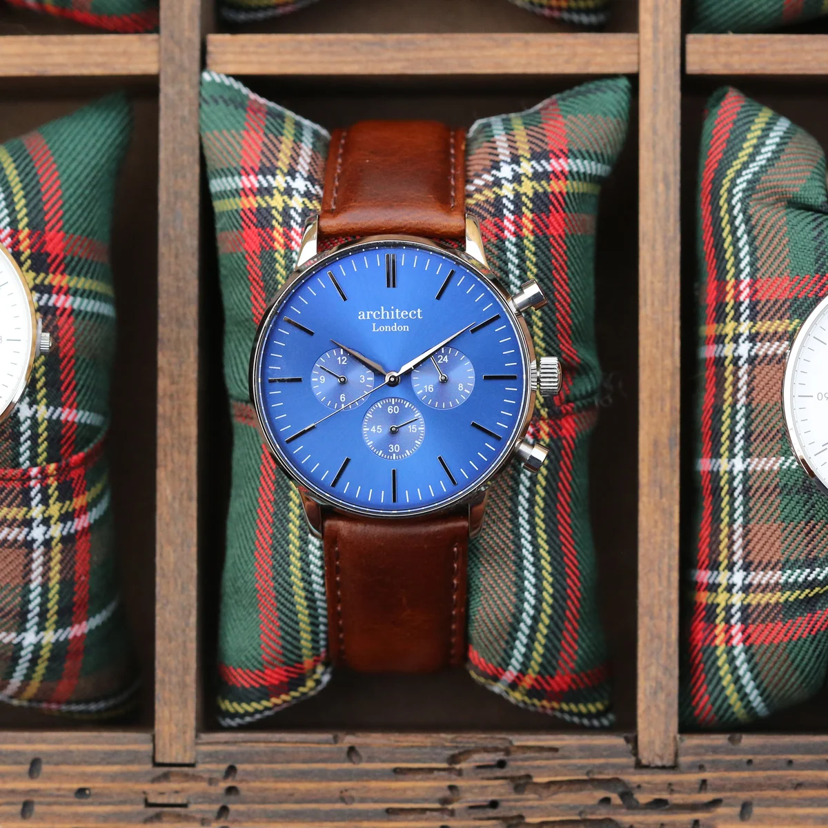 Men’s personalised watch with deep-space blue dial, walnut brown leather strap, and three chronograph subdials on wrist