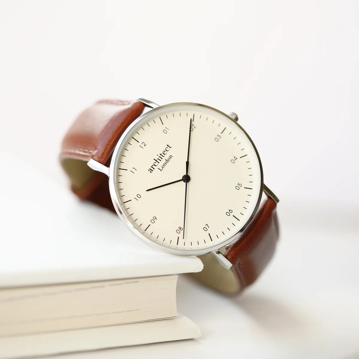 Men's minimalist stainless steel case watch with walnut leather strap and modern font engraving on backplate