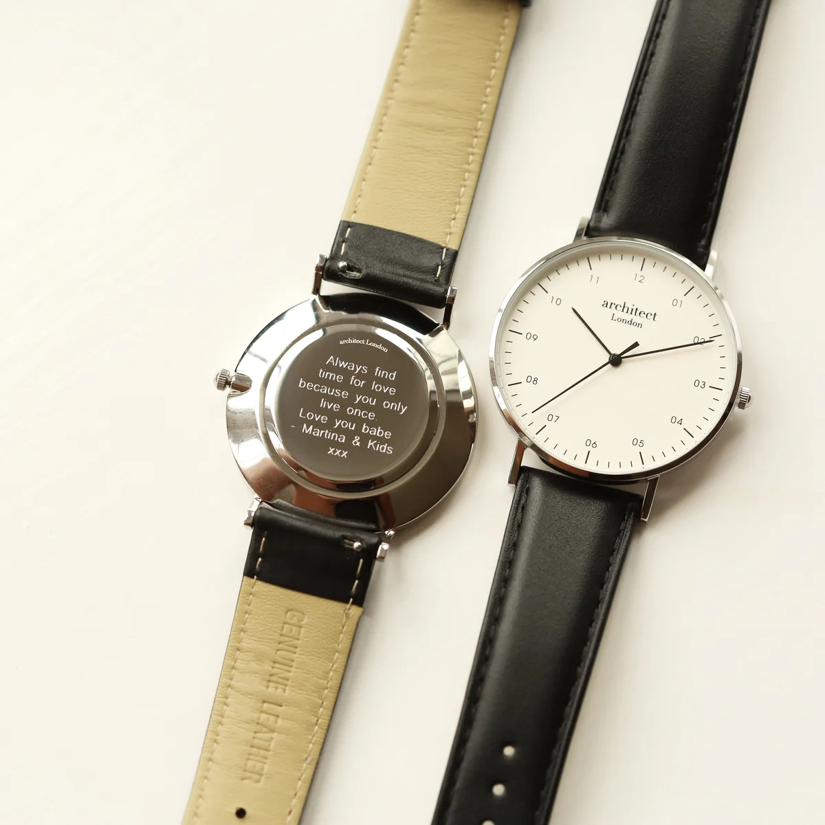 Personalised men's watch with minimalist white dial, modern font engraving, polished stainless steel case, and black leather strap