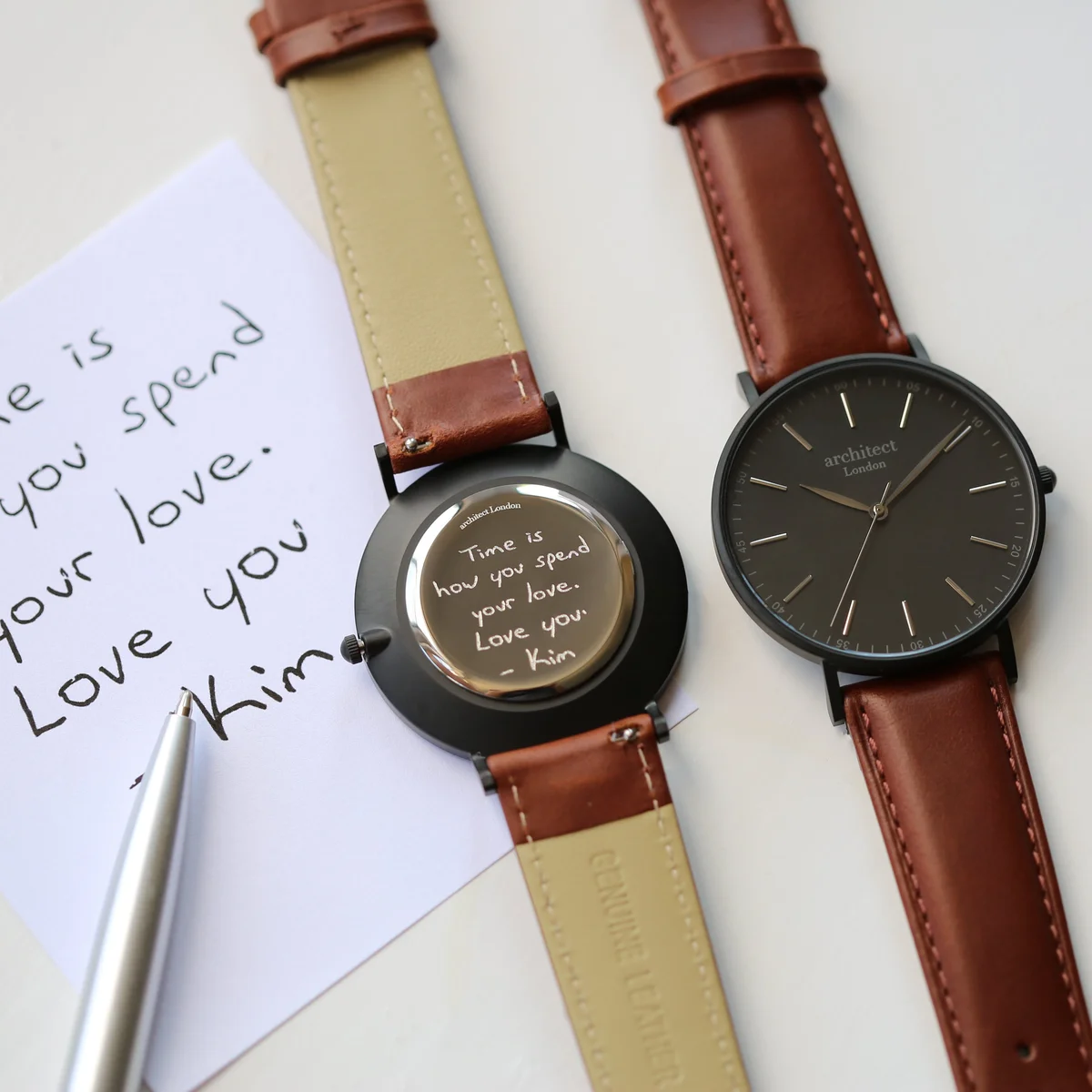 Personalised men's watch with minimalist black dial, walnut leather strap, and stainless steel case on white background