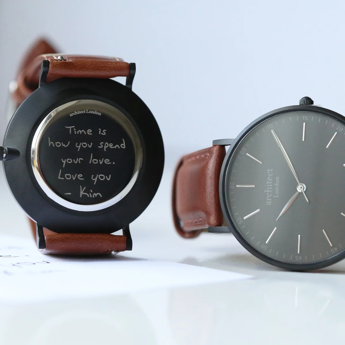Men’s minimalist quartz movement watch with walnut leather strap and brushed stainless steel case on white background