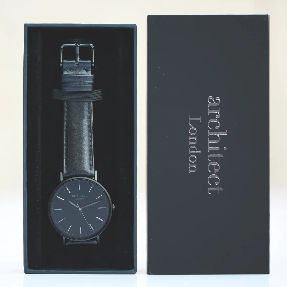 Men's minimalist watch with jet black genuine leather strap and brushed stainless steel case on white background
