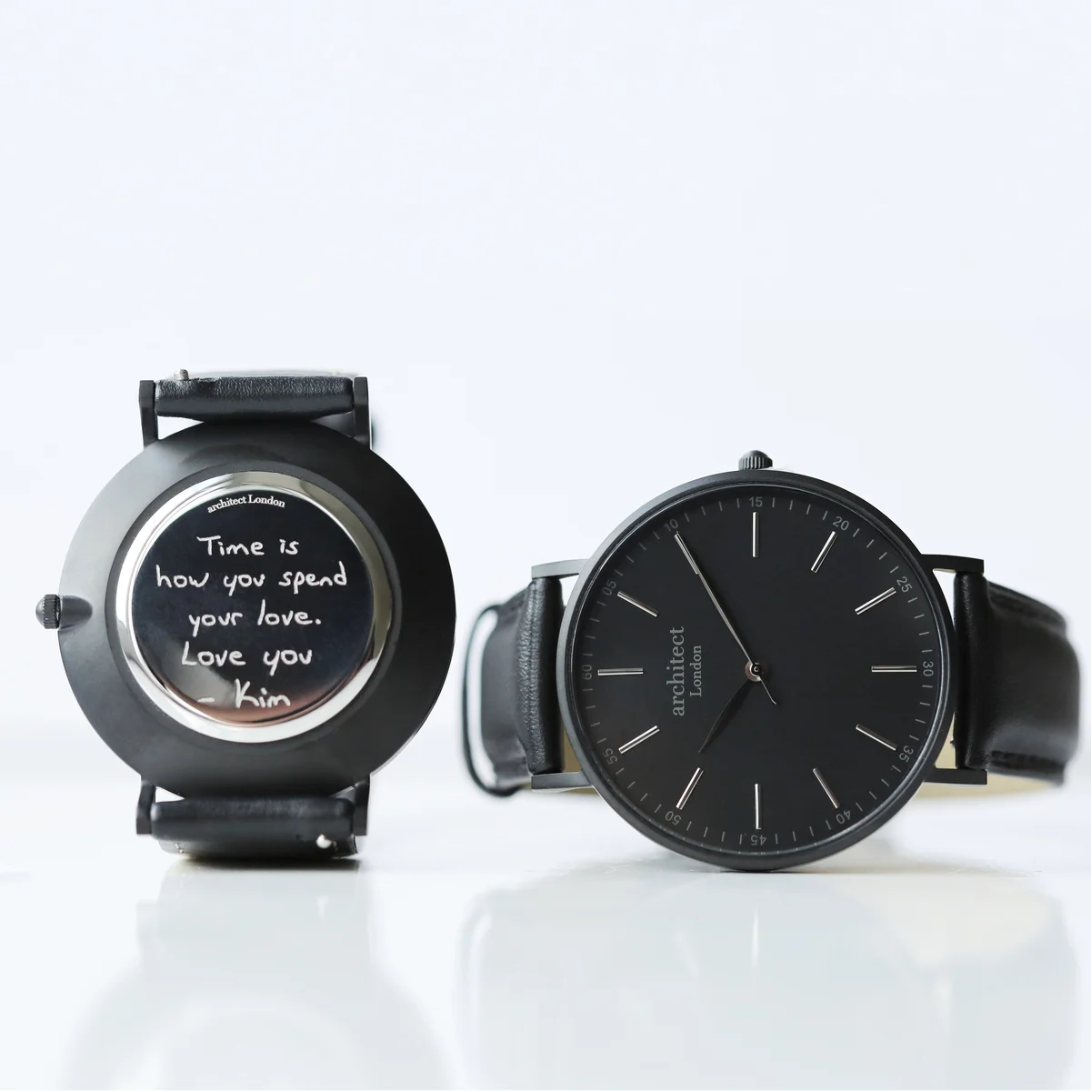 Men's minimalist watch with jet black genuine leather strap and brushed stainless steel case on white background