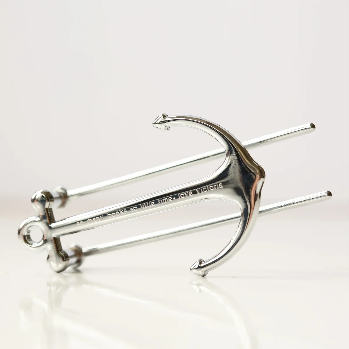 Silver and black personalised book anchor holding open a book, presented in a gift box, ideal book accessory gift