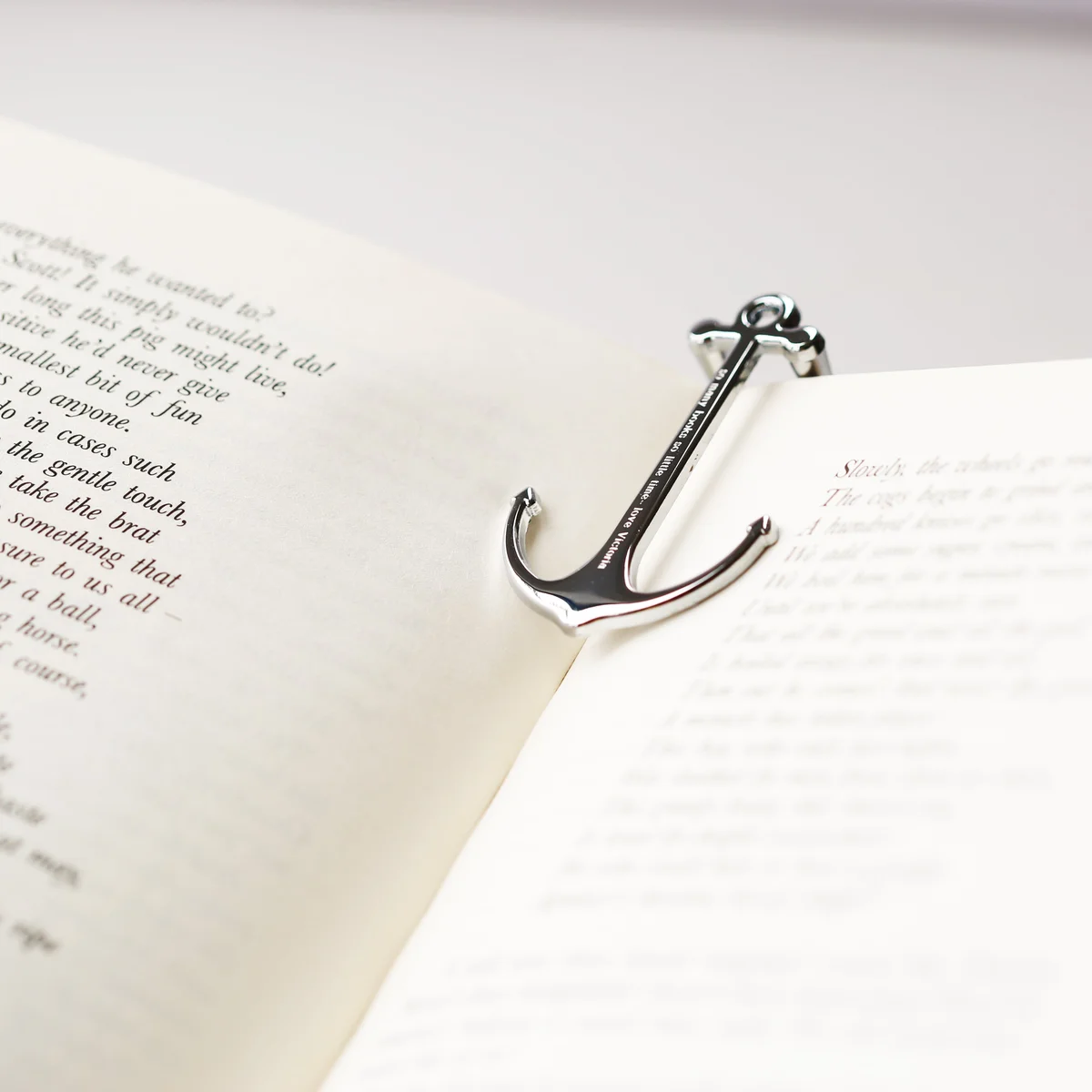 Silver and black personalised reading book holder made of polished metal with engraved message, shown with gift box