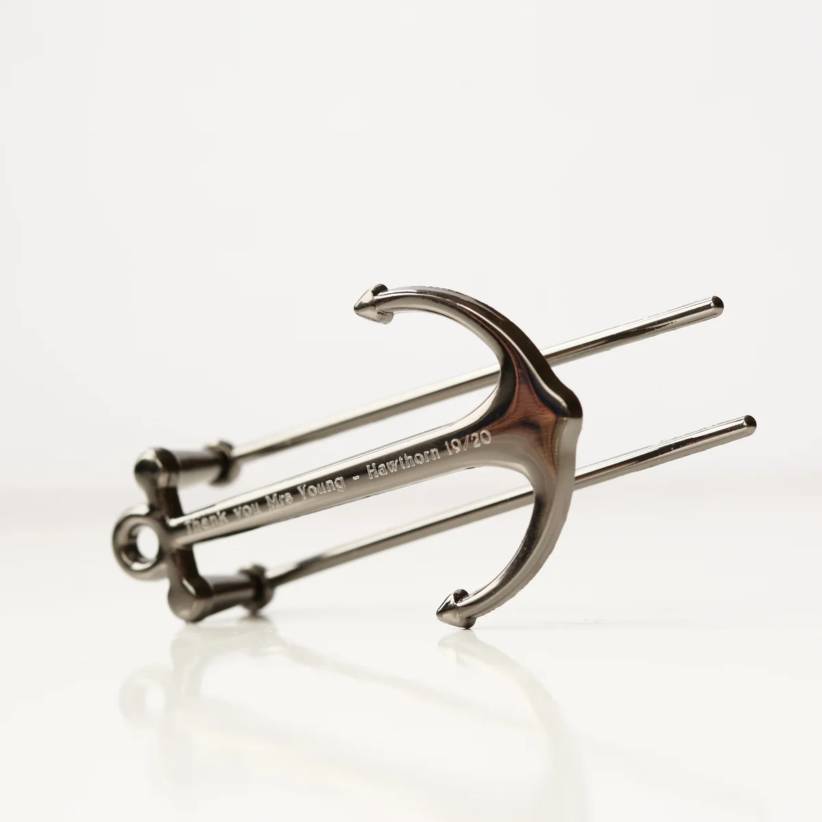 Silver and black personalised book anchor with engraved message, polished metal, shown in gift box on white background