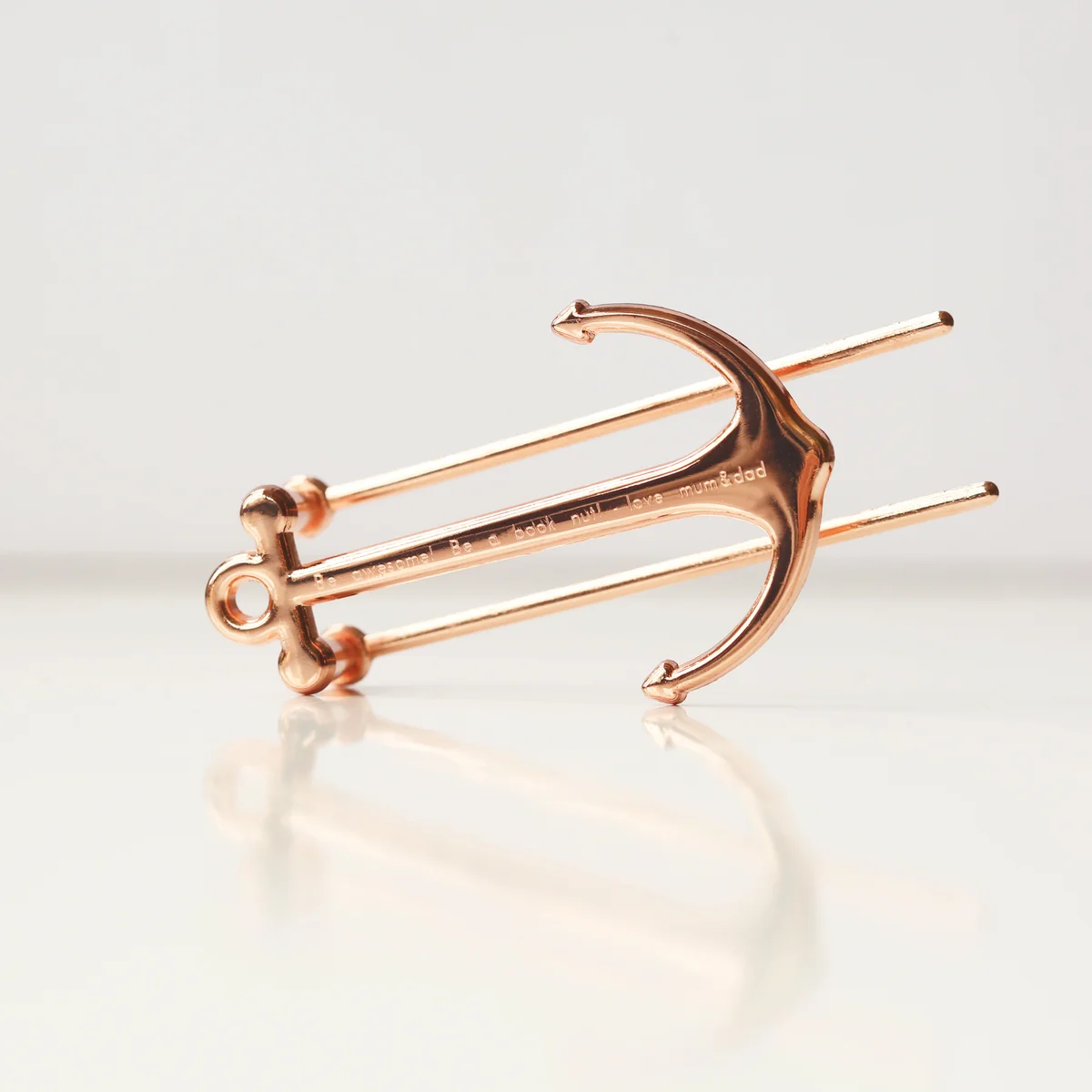 Gold and rose gold engraved book holder made of polished metal, shown with personalised engraving and gift box