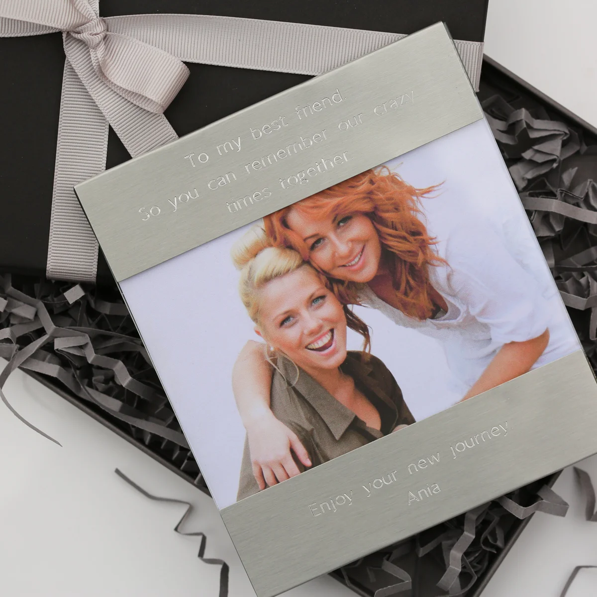 Personalised photo frame in polished stainless steel with modern font engraving, holding a 125x80mm photo, 145x125mm frame size