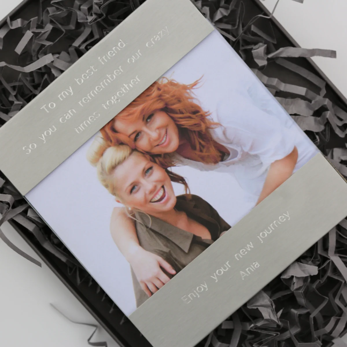 Polished stainless steel modern photo frame with engraved top and bottom sections, holding a 125mm by 80mm photo.