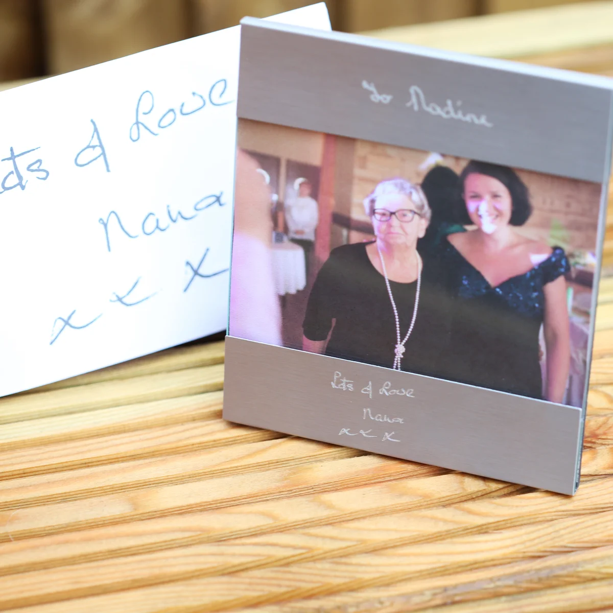 Personalised handwriting photo frame in brushed stainless steel holding a 125x80mm photo with engraved handwriting above and below
