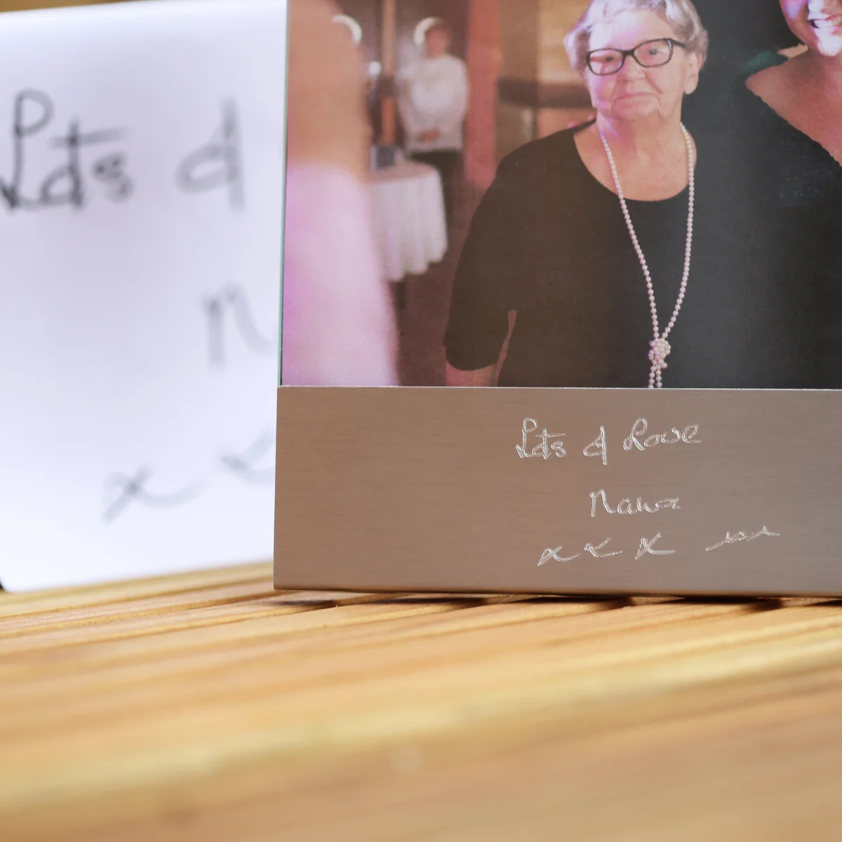 Brushed stainless steel photo frame with engraved handwriting and space for a 125mm by 80mm photo, modern design