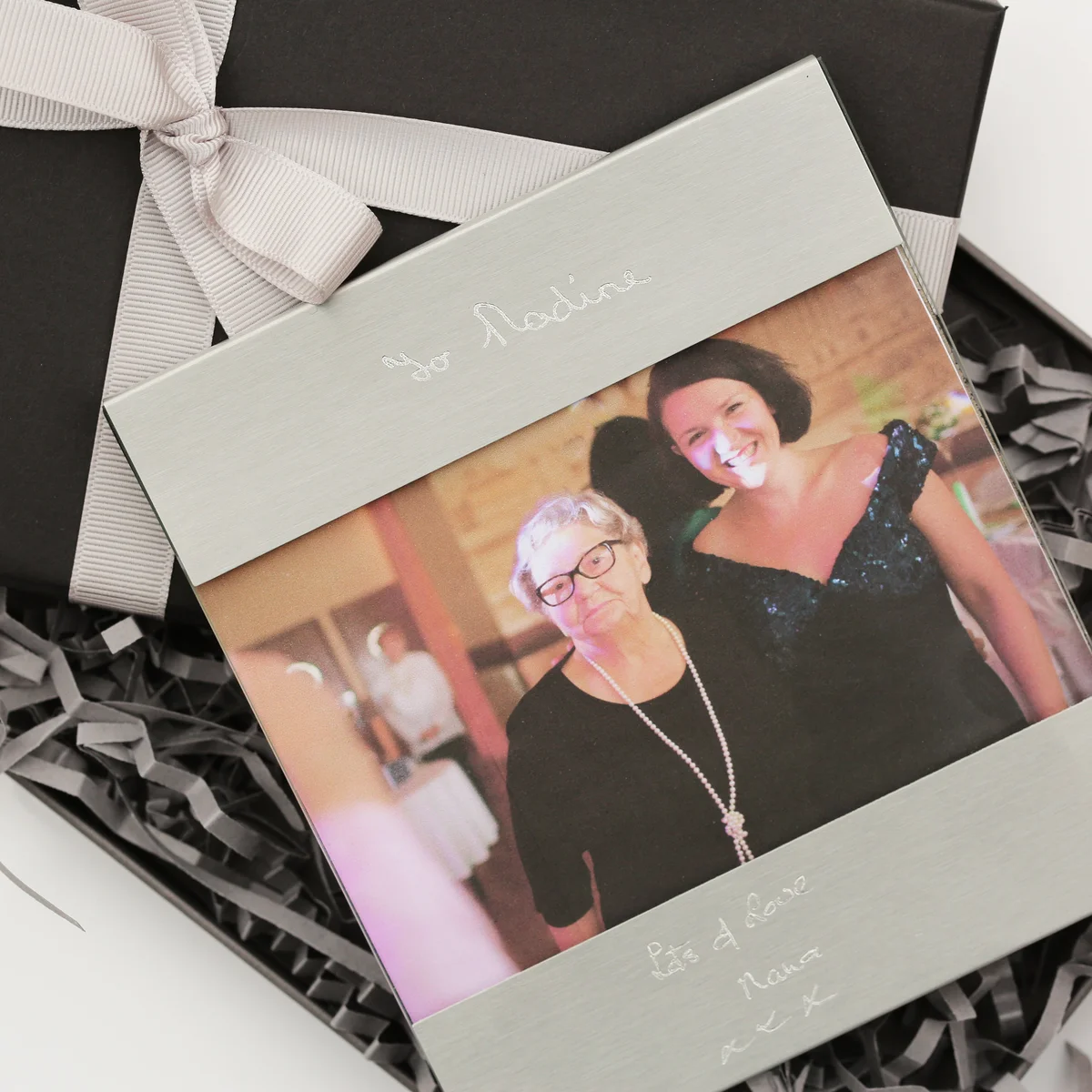 Brushed stainless steel custom handwriting frame displaying engraved personal message above and below photo slot