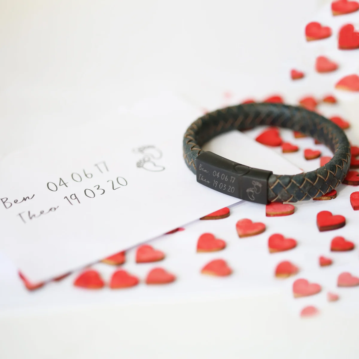 Iron-colored men's leather bracelet with engraved handwriting on woven leather strands and magnetic snap clasp