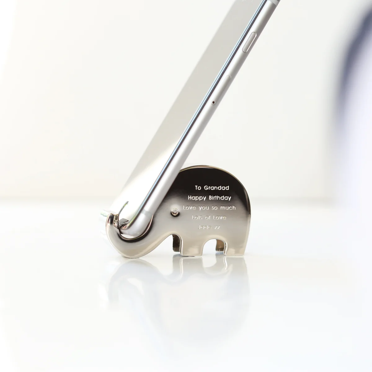 Personalised phone holder shaped like a polished stainless steel elephant balancing a phone on its trunk