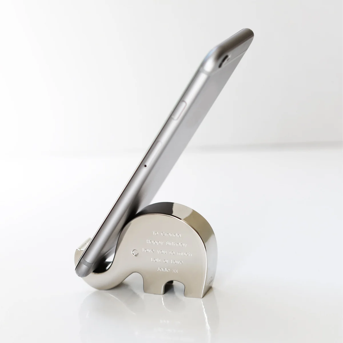 Engraved phone holder shaped like an elephant balancing a phone on its polished stainless steel trunk