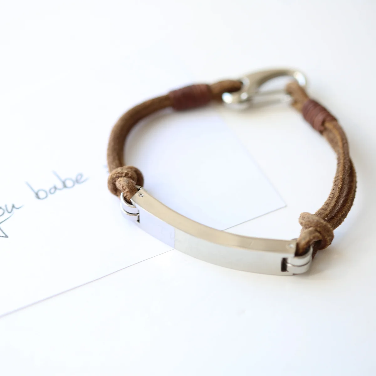 Tan genuine leather engraved men's bracelet with snap-lock clasp and personalized handwriting engraving on display