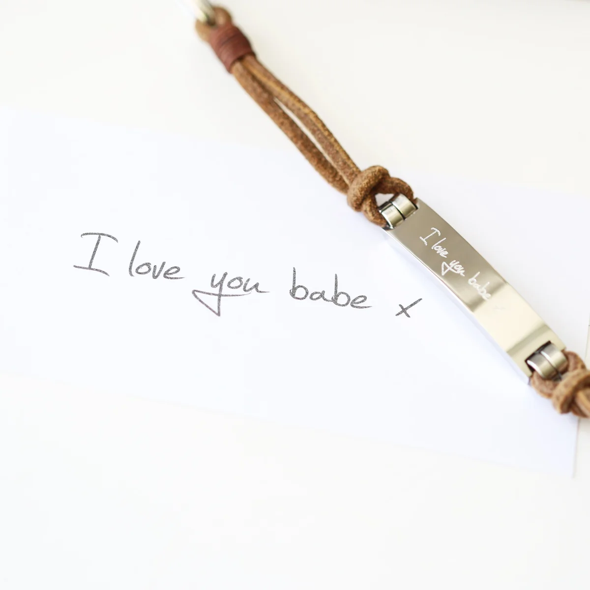 Tan leather men's bracelet with snap-lock clasp, personalised with handwriting engraved bracelet detail on wide band