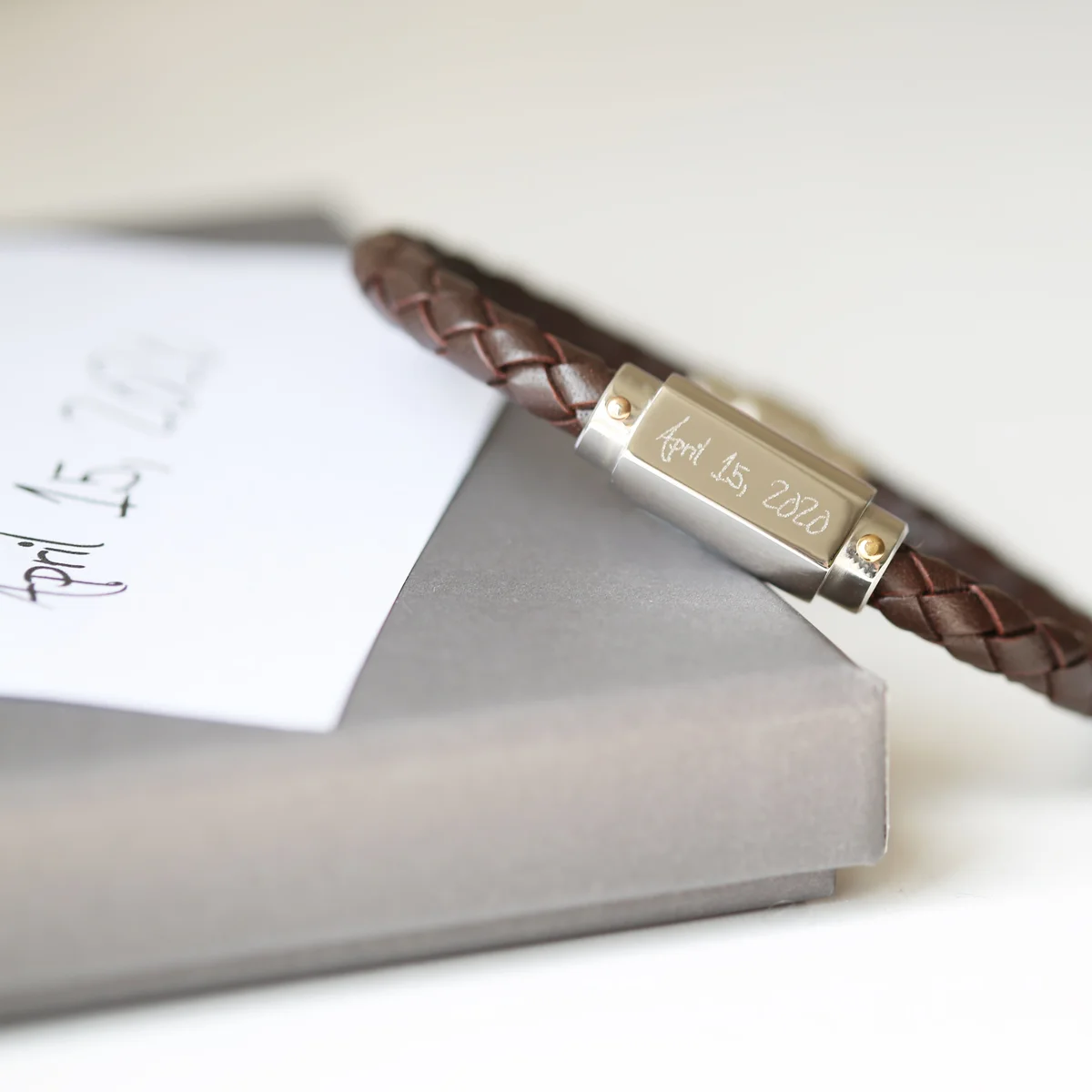 Personalised leather bracelet with twisted genuine leather and stainless steel magnetic snap-lock clasp on white background