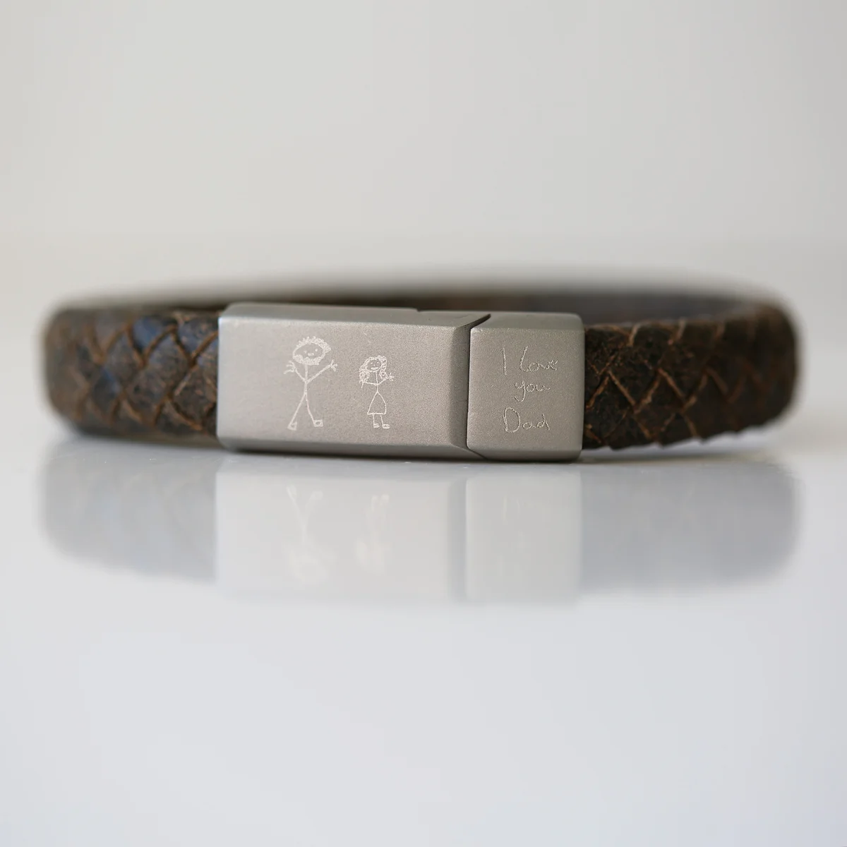 Rustic genuine leather engraved handwriting bracelet with woven strands and magnetic snap-lock clasp on white background
