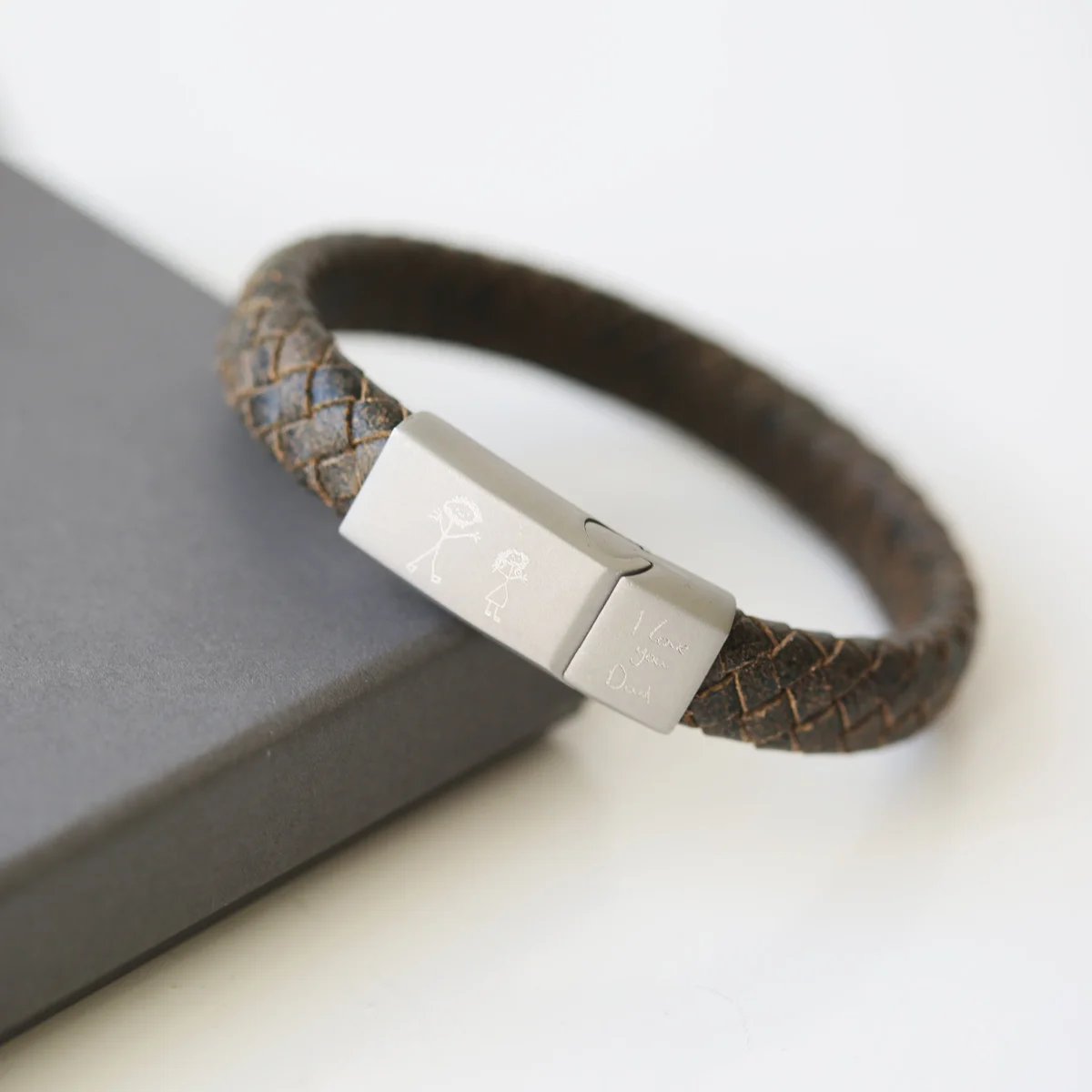 Rustic men's leather bracelet with woven strands and personalized handwriting engraving on a magnetic snap clasp