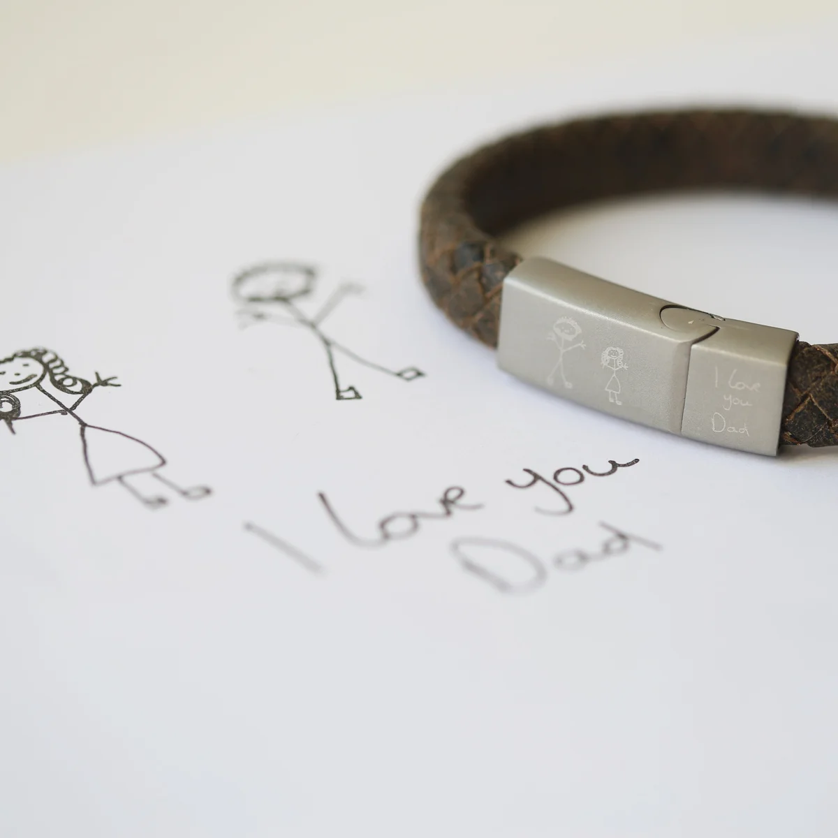 Rustic genuine leather magnetic snap lock bracelet with engraved custom handwriting on woven strands, shown on wrist