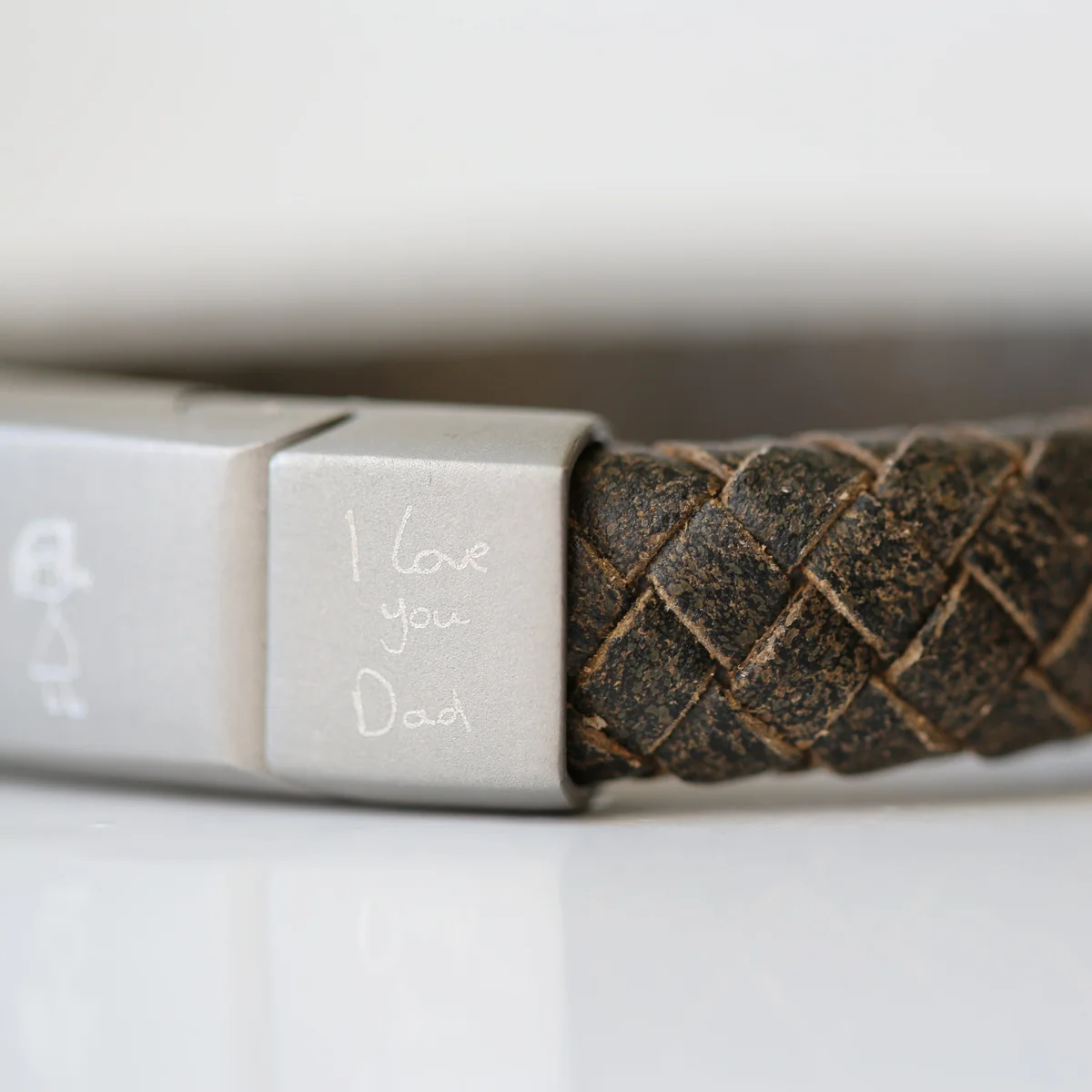 Rustic leather bracelet with woven genuine leather strands and engraved handwriting on a magnetic snap-lock clasp