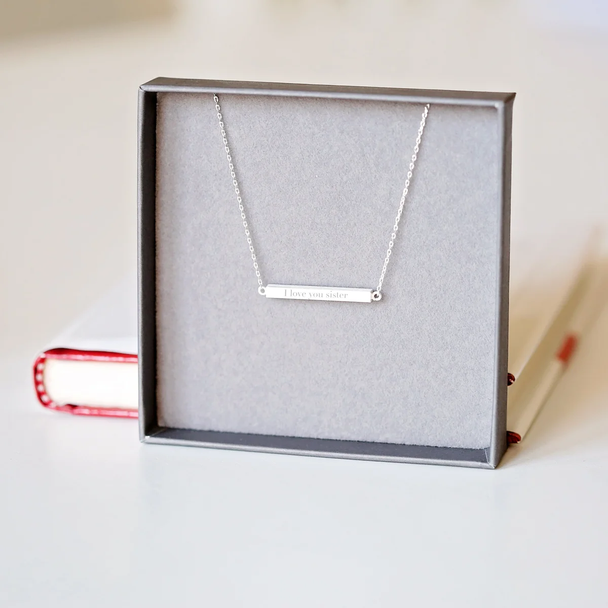 Personalised horizontal necklace in rose gold with modern engraved bar on adjustable 49cm chain displayed on white background