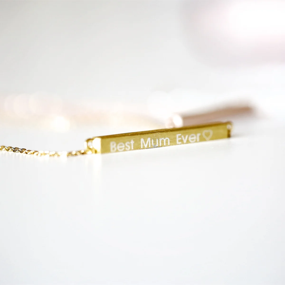 Personalised engraved necklace in silver with horizontal bar pendant on adjustable 49cm chain displayed on white background