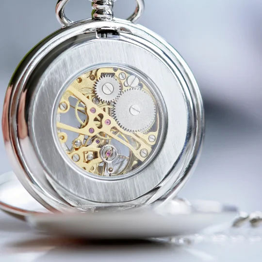 Engraved pocket watch with skeleton dial showing mechanical movement, personalised with own handwriting on front and back