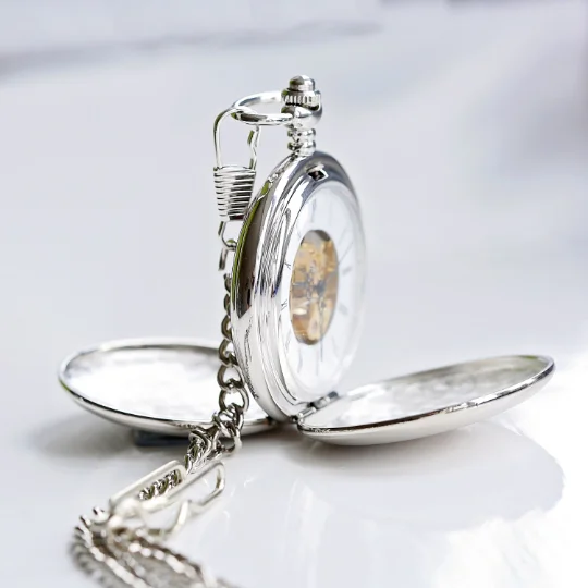 Personalised skeleton pocket watch showing intricate mechanical movement with custom handwriting engraving on front and back
