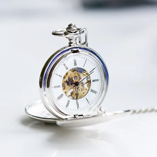 Dual opening pocket watch showing engraved modern font message on front and visible skeleton mechanical movement inside