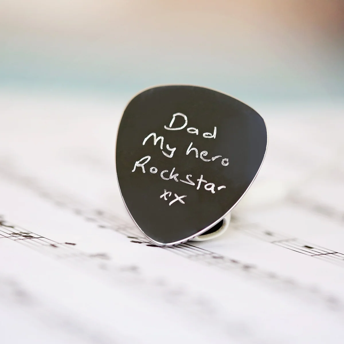 Custom guitar plectrum engraved with handwritten message, polished stainless steel in gift box with satin ribbon and blue shred